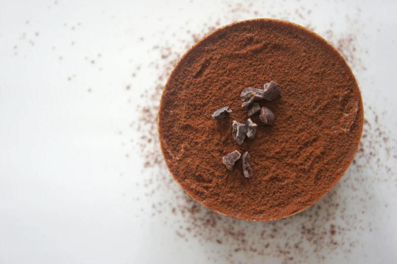 a close up of a bowl of food on a table, fully chocolate, powder, detailed product image, fan favorite