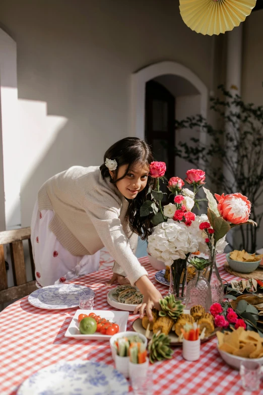 a woman sitting at a table with plates of food, girl in flowers, ameera al taweel, sunny afternoon, action shot