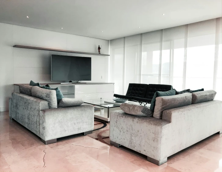 a living room filled with furniture and a flat screen tv, inspired by Emilio Grau Sala, unsplash, minimalism, pink concrete, penthouse, glossy white metal, modern photo