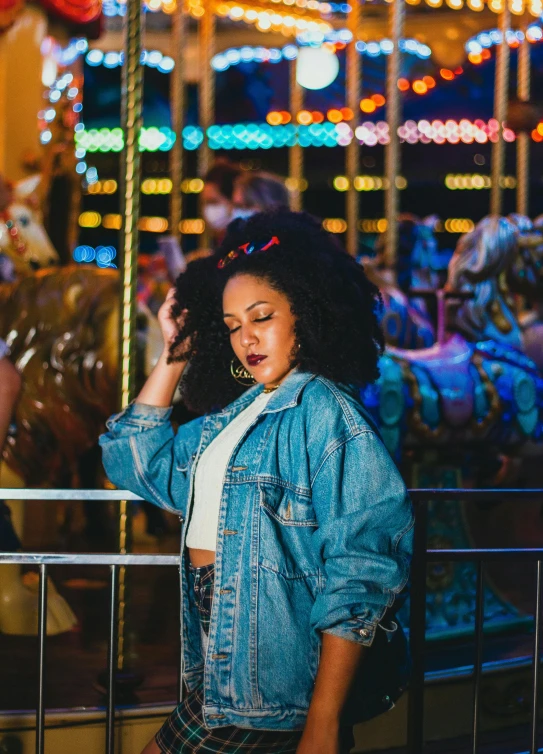 a woman standing in front of a carousel at night, an album cover, pexels contest winner, funk art, denim jacket, profile image, doja cat, having fun. vibrant