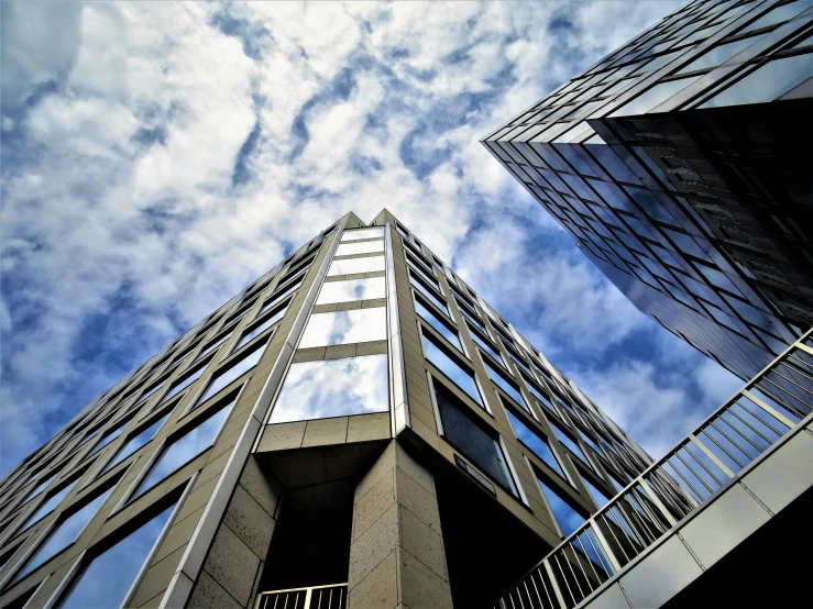 a couple of tall buildings sitting next to each other, a photo, pexels contest winner, bauhaus, worms eye view, thumbnail, multiple stories, wide angle exterior 2022