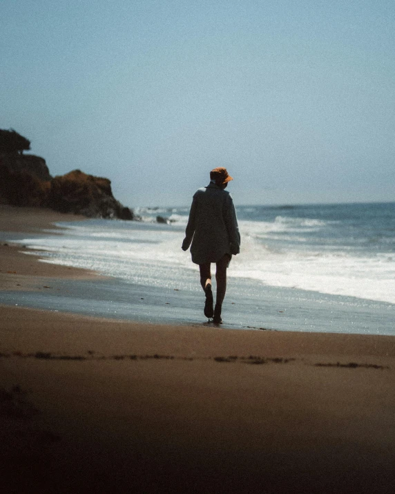 a person walking on a beach near the ocean, lgbtq, instagram photo, leaving a room, no watermark