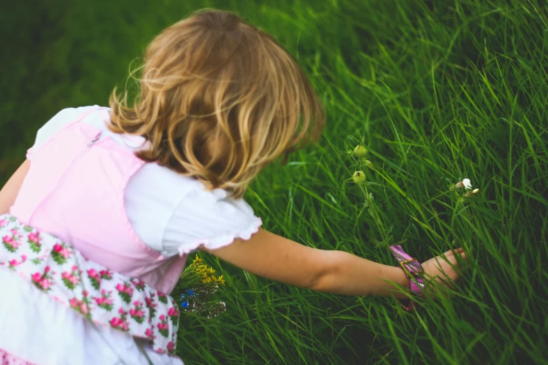 a little girl that is standing in the grass, pexels, pink white and green, exploring, an intruder, touching