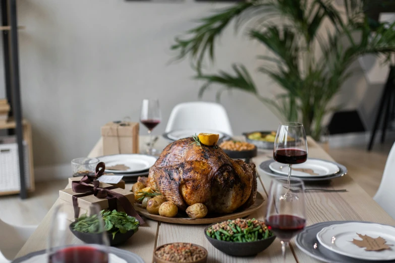 a large turkey sitting on top of a wooden table, by Carey Morris, pexels contest winner, renaissance, “ iron bark, festive atmosphere, on a white table, middle eastern