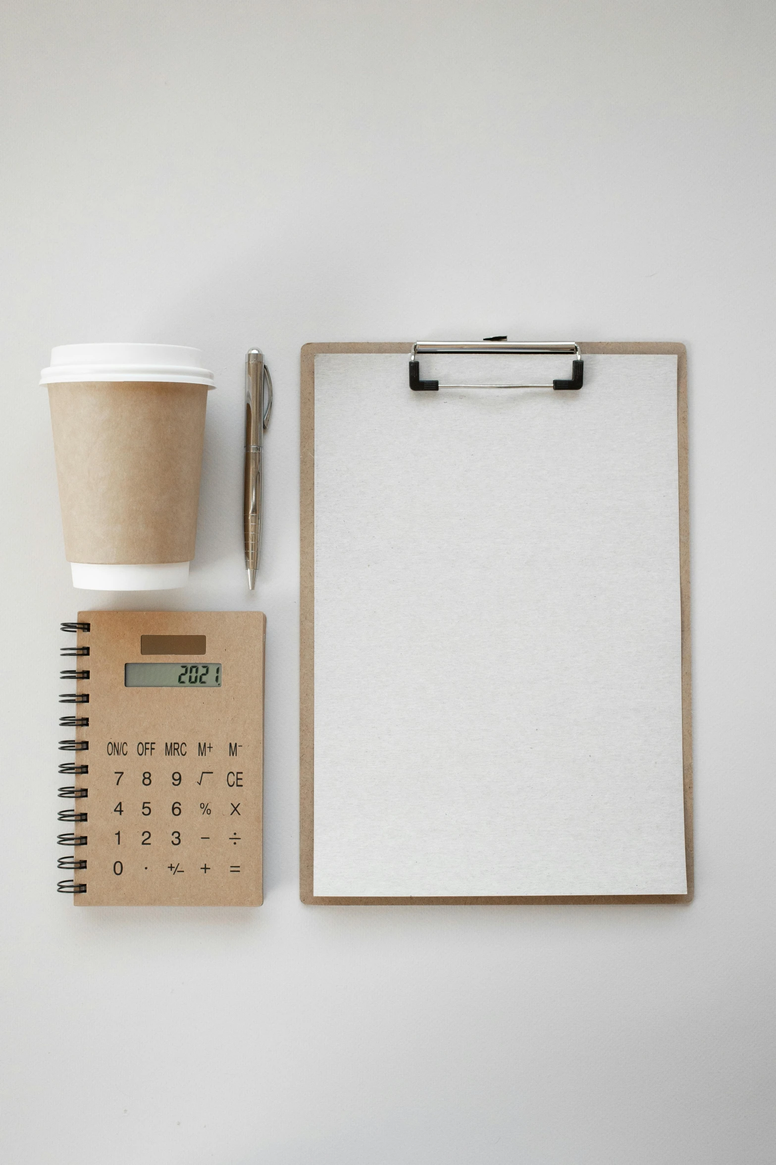 a notepad next to a cup of coffee and a calculator, minimalism, thumbnail, sustainable materials, 9 9 designs, leaked image