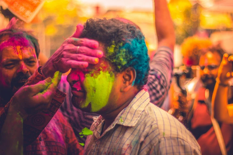 a group of people covered in colored powder, pexels contest winner, indian style, 🎨🖌️, photo of a man, holiday season
