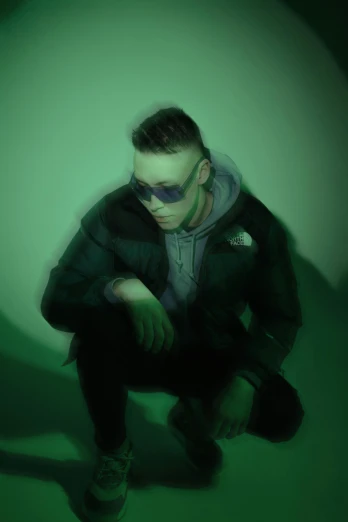 a man sitting on the ground in a dark room, an album cover, inspired by Ion Andreescu, trending on pexels, green and purple, cyberpunk eye wear, shaved sides, slight haze