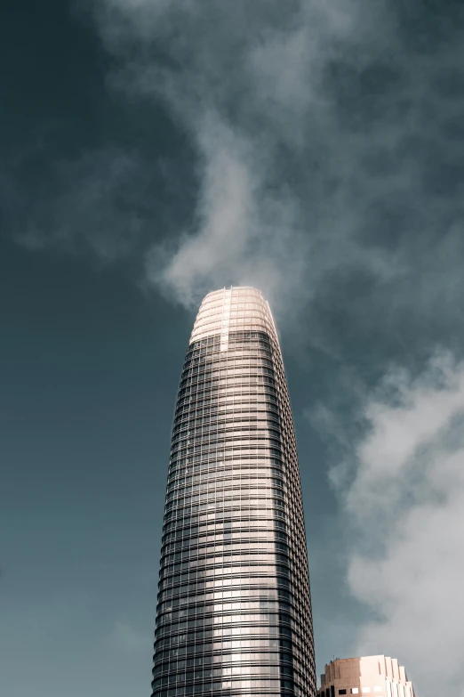 a very tall building sitting in the middle of a city, unsplash contest winner, light and space, swirling fog, california;, futuristic architecture concept, smoke rising from the pipe