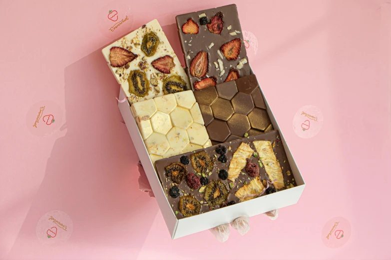 a close up of a box of food on a table, fully chocolate, flat lay, strawberry fields forever, honeycomb