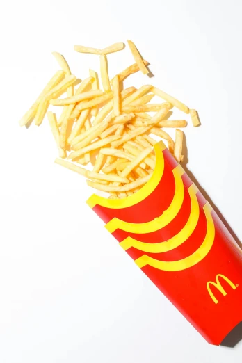 a box of french fries sitting on top of a table, mcdonald, tall thin, splash image, f/1.4
