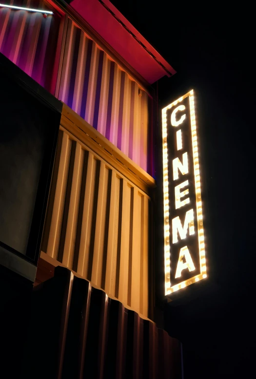 a cinema marquee lit up at night, poster art, by Everett Warner, unsplash, 35mm color photo, a wooden, **cinematic, contain
