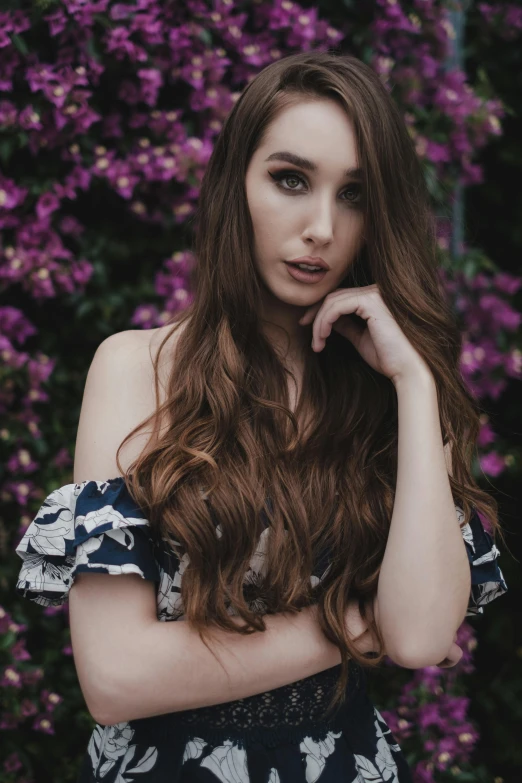 a beautiful young woman posing in front of purple flowers, a colorized photo, pexels contest winner, long wavy brown hair, crop top, gif, beautiful pretty young