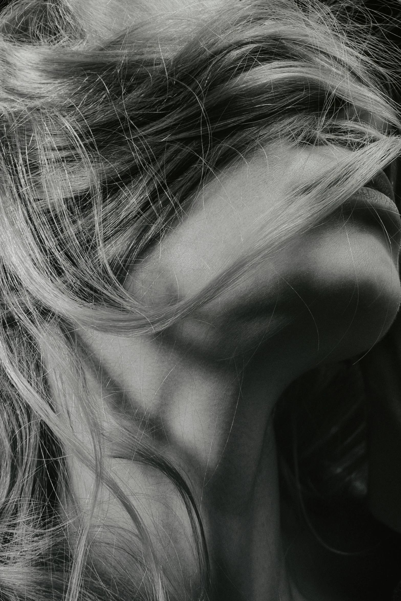 a black and white photo of a woman with long hair, trending on pexels, conceptual art, close up of a blonde woman, shy looking down, back of head, distraught