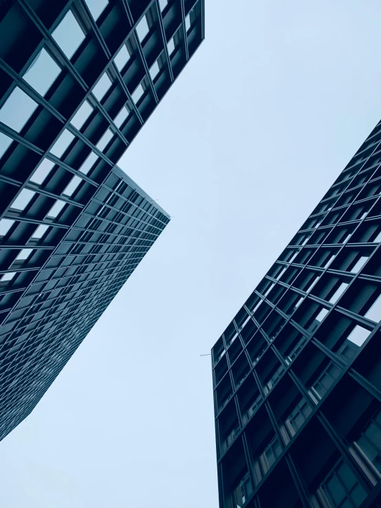 a couple of tall buildings next to each other, by Adam Rex, pexels contest winner, upward perspective, thumbnail, multiple stories, high definition screenshot