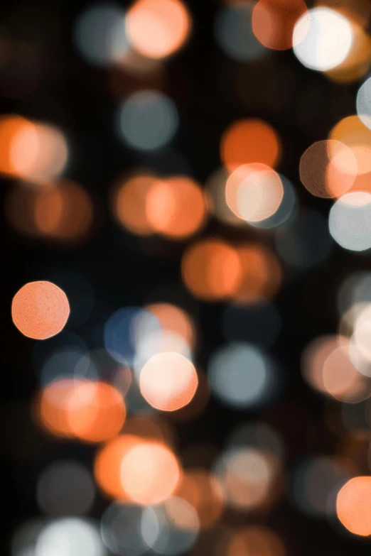 a blurry image of a bunch of lights, trending on unsplash, dark grey and orange colours, varying dots, bubbly, paul barson