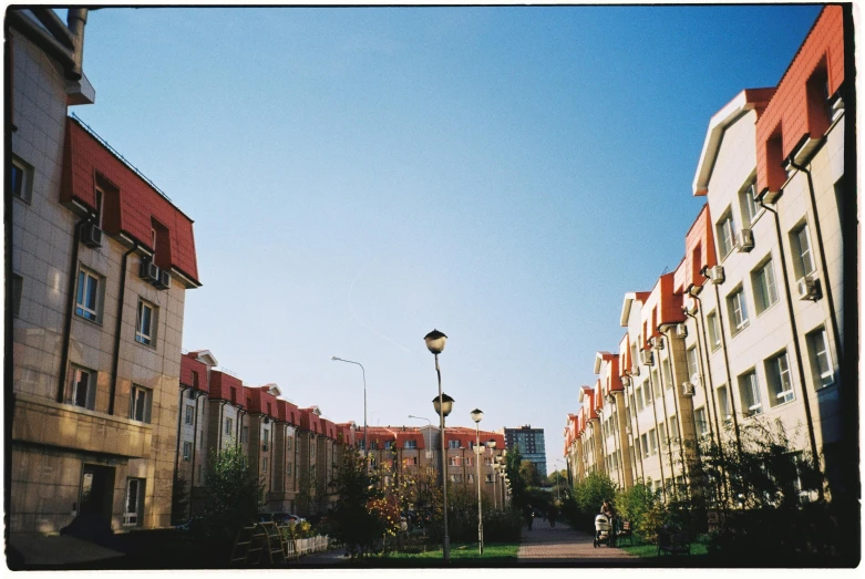a couple of buildings that are next to each other, an album cover, unsplash, post - soviet courtyard, 2000s photo, slightly sunny, kodak film photo