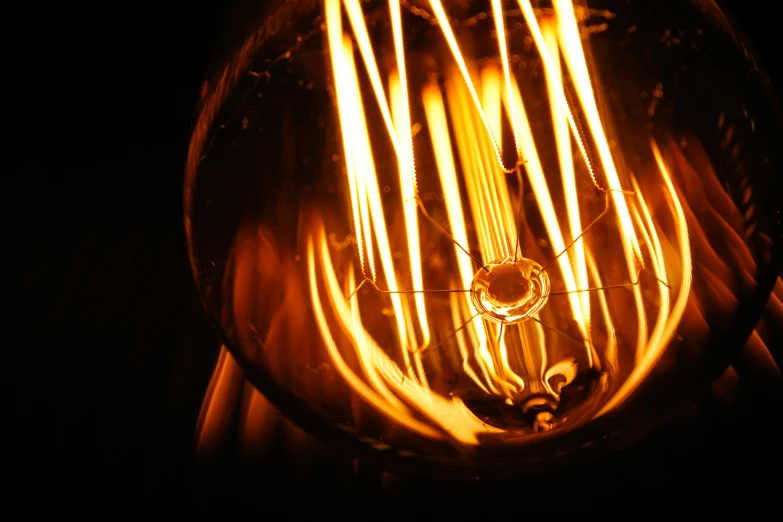 a close up of a light bulb in the dark, renaissance, illuminated lines, holding fire and electricity, warm yellow lights, instagram post
