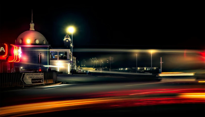 a blurry photo of a city street at night, by Peter Churcher, pexels contest winner, art photography, seaside, light trail, bus station, panoramic photography