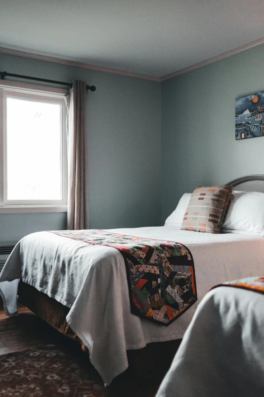 a couple of beds in a bedroom next to a window, by Carey Morris, furnished room, window view, inuit, thumbnail