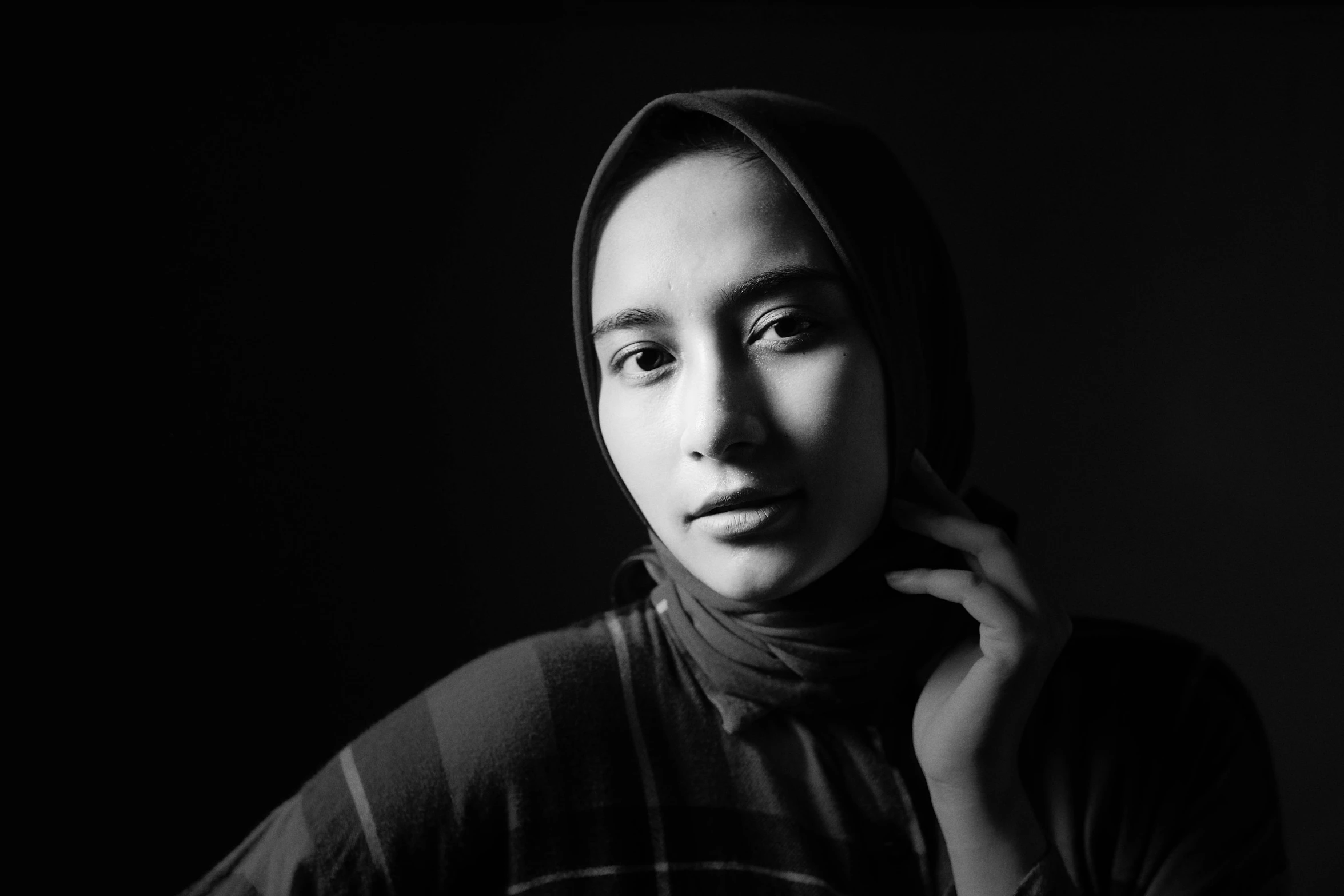 a black and white photo of a woman in a hijab, inspired by Yousuf Karsh, unsplash contest winner, portrait of teenage girl, studio medium format photograph, 🤤 girl portrait, a young asian woman