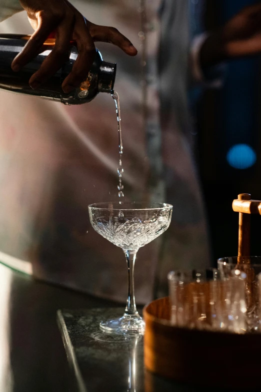 a person pouring a drink into a glass, by Ndoc Martini, renaissance, intricate sparkling atmosphere, zoomed in, ice - carving, smooth tiny details