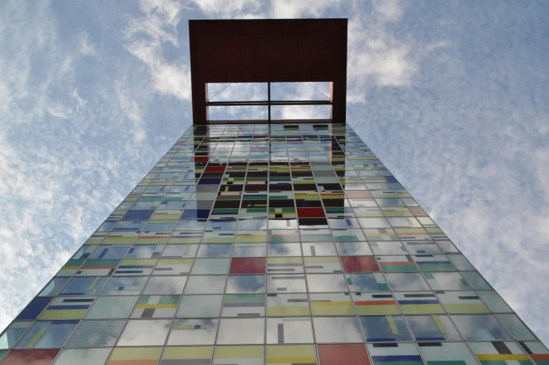 a tall multicolored building with a sky background, inspired by Karel Dujardin, flickr, glass studio, delft, squares, looking onto the horizon