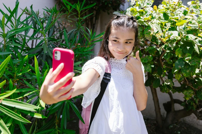 a little girl taking a selfie with her cell phone, a picture, shutterstock, happening, avatar image, isabela moner, school, tiktok video