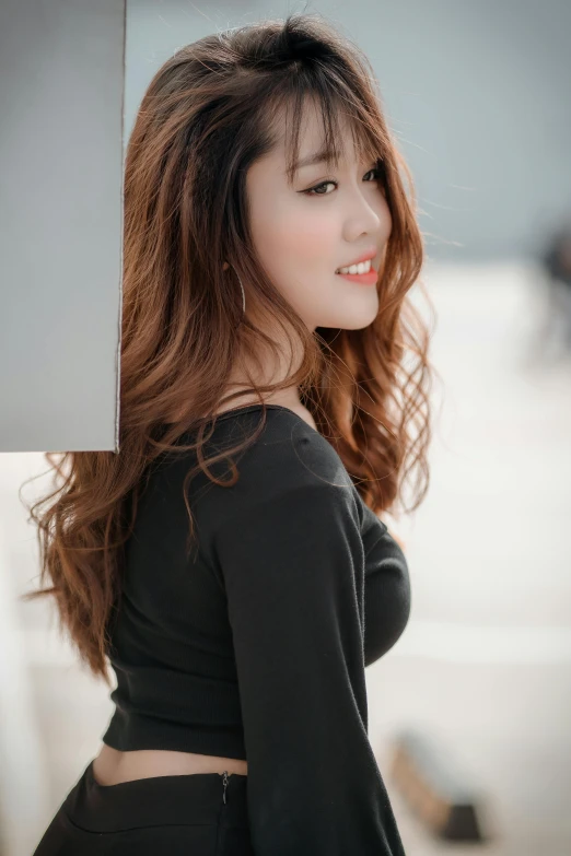 a woman in a black top posing for a picture, hair : long brown, asian features, 5 0 0 px models, profile pic