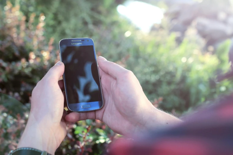 a close up of a person holding a cell phone, by Matthew Smith, pexels, in the garden, avatar image, 15081959 21121991 01012000 4k, angled shot