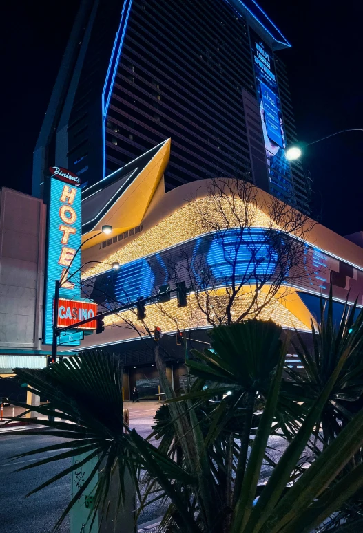 the exterior of a hotel lit up at night, by Ryan Pancoast, sin city, avatar image, multiple stories, taken in the early 2020s