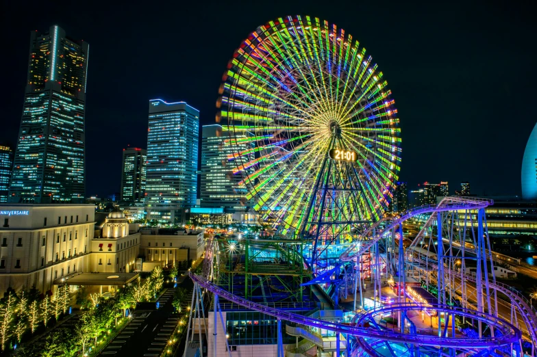 a ferris wheel in the middle of a city at night, n eddy take a trip to tokyo, slide show, bright vivid color hues:1, gigapixel photo