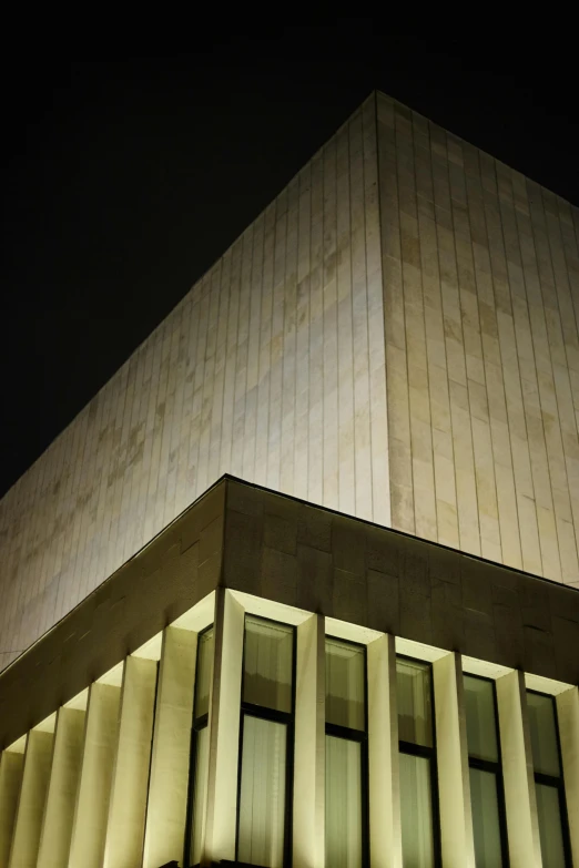 the top of a tall building lit up at night, an album cover, inspired by David Chipperfield, unsplash, brutalism, smithsonian museum, photo of a big theaterstage, close up shot from the side, stockholm