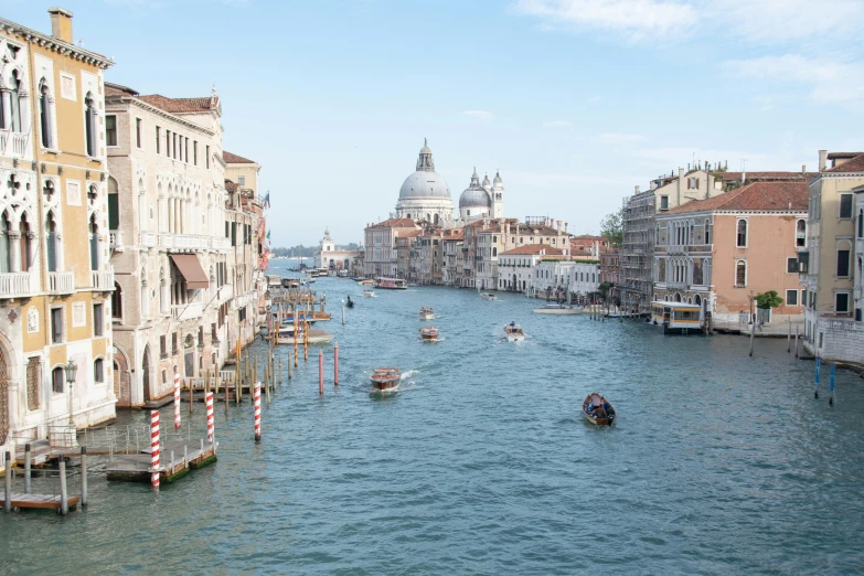 a canal filled with lots of boats next to tall buildings, by Canaletto, pexels contest winner, venice biennale's golden lion, 2 0 2 2 photo, white marble buildings, “diamonds