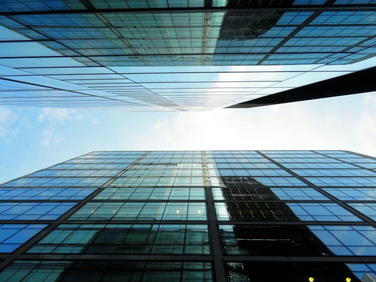 a very tall building with a lot of windows, inspired by Richard Wilson, unsplash, square, corporate, two towers, view from the ground