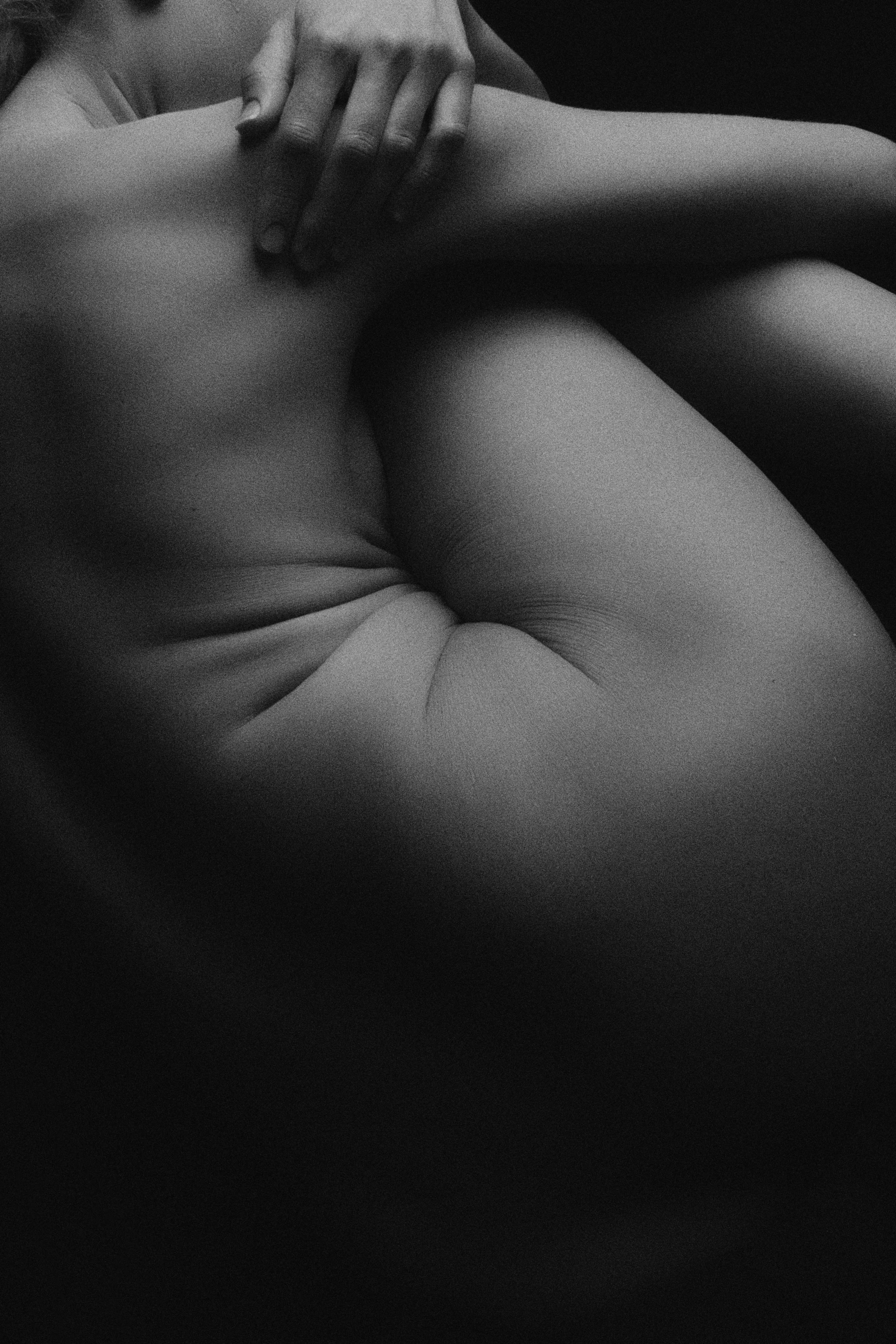 a black and white photo of a naked woman, a black and white photo, by Maciej Kuciara, unsplash, conceptual art, tufted softly, folds of belly flab, hug, deep colours. ”