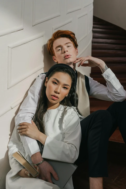 a man and a woman sitting next to each other, an album cover, inspired by Wang Duo, trending on pexels, renaissance, hr ginger, asian man, elegant pose, androgynous person