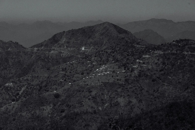 a black and white photo of a mountain range, realism, uttarakhand, city on a hillside, slightly pixelated, ffffound