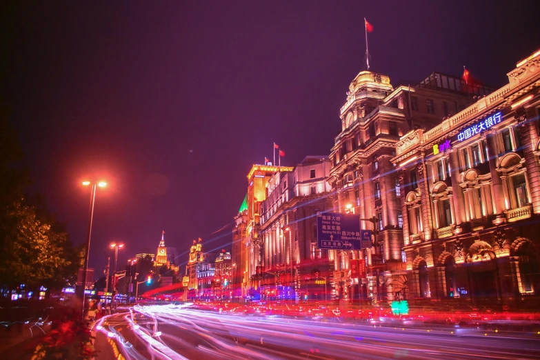 a city street filled with lots of traffic at night, by Bernardino Mei, pexels contest winner, visual art, chinese building, shanghai, purple and yellow lighting, square