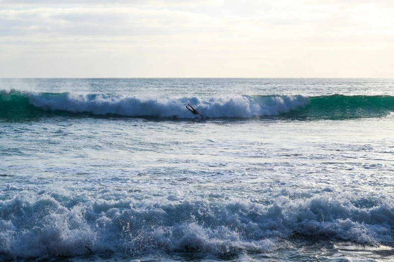 a man riding a wave on top of a surfboard, pexels contest winner, hurufiyya, ocean shoreline on the horizon, australian beach, hollister ranch, cresting waves and seafoam