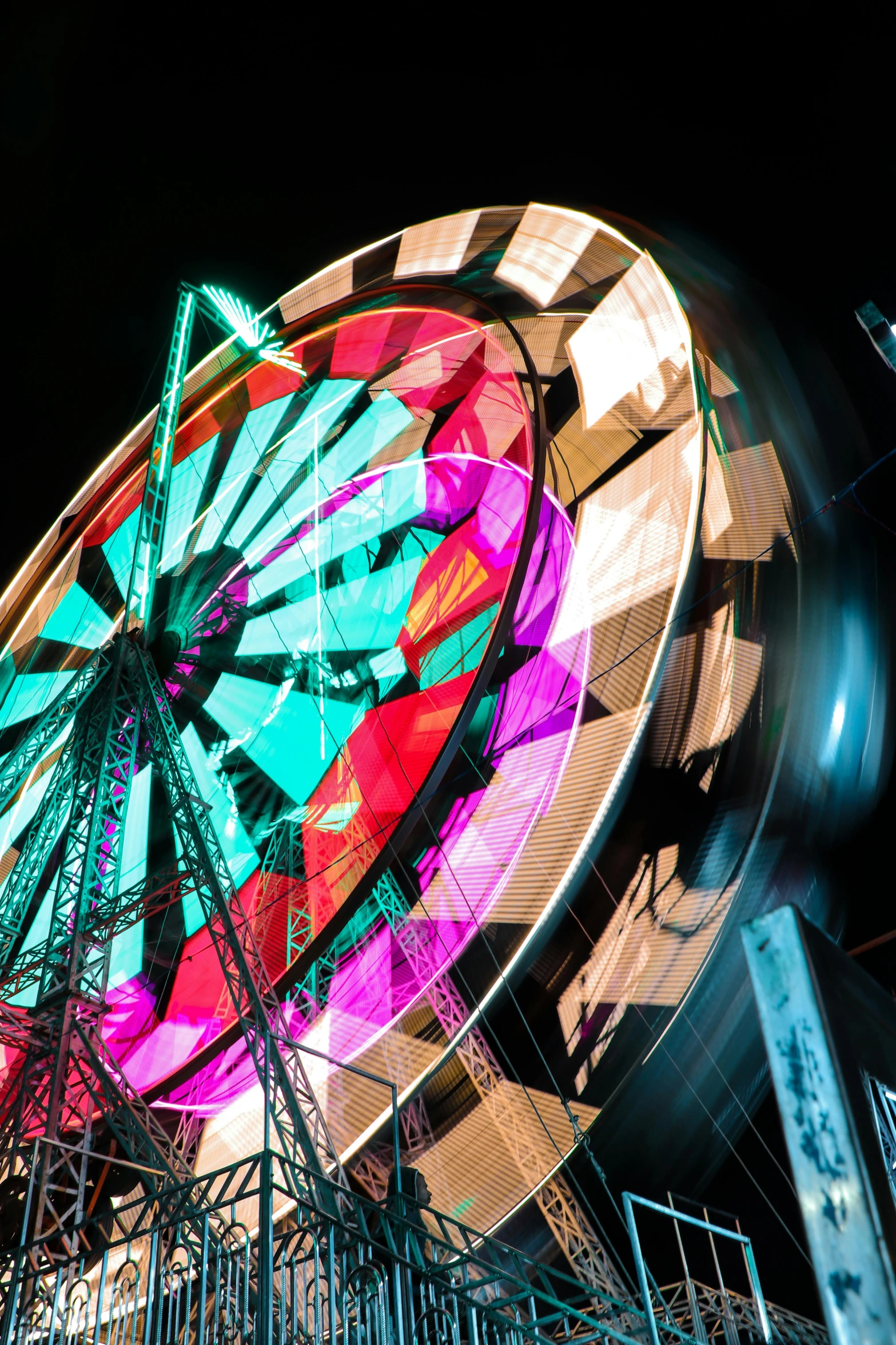 a ferris wheel is lit up at night, a portrait, by Dave Melvin, multicolored, high - contrast, slide show, wheel