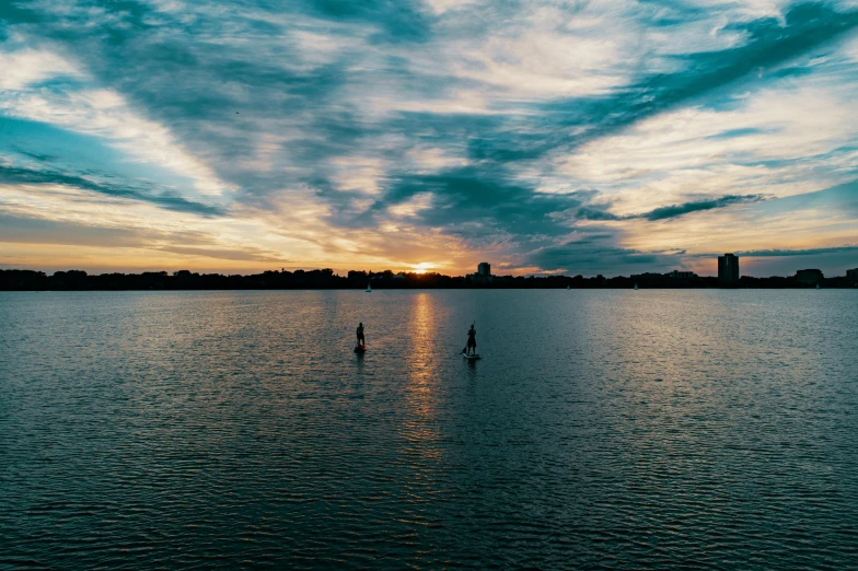 a couple of boats floating on top of a lake, by Washington Allston, unsplash contest winner, people walking into the horizon, sup, late afternoon, minn