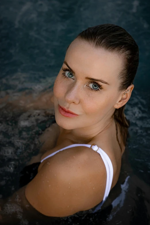 a woman in a pool with a frisbee in her hand, a portrait, inspired by Anna Boch, unsplash, perfect face model, camilla luddington, square, 3 8 - year - old