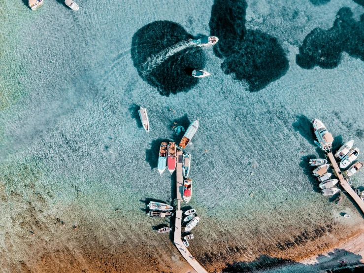a group of boats floating on top of a body of water, a screenshot, by Carey Morris, pexels contest winner, hurufiyya, airborne view, near a jetty, hawaii, graphic print
