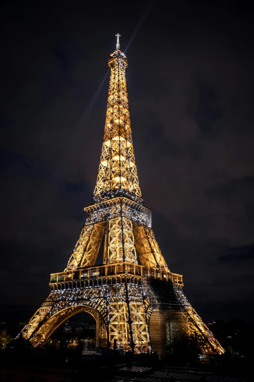 the eiffel tower lit up at night, slide show, stacked image