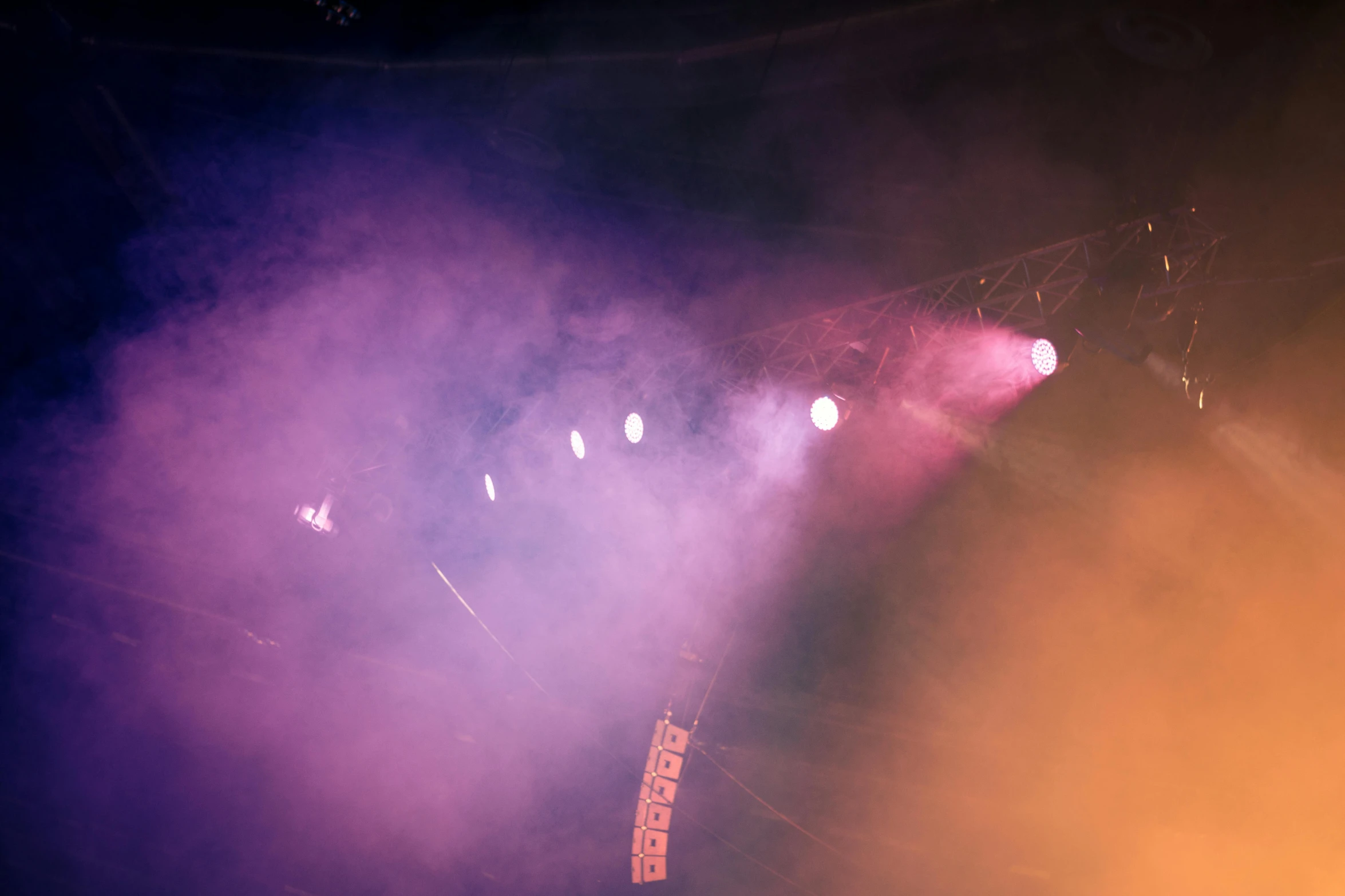 a man riding a snowboard on top of a snow covered slope, pexels, light and space, 2 rappers on stage at concert, lights through fog, stage at a club, purple and yellow lighting