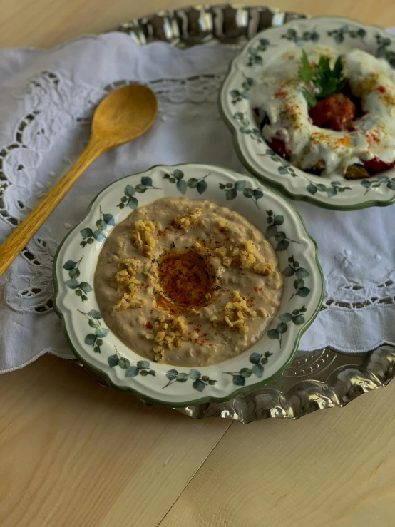 a close up of two plates of food on a table, inspired by Modest Urgell, dau-al-set, the god of oatmeal, portrait n - 9, chuvabak, traditional medium