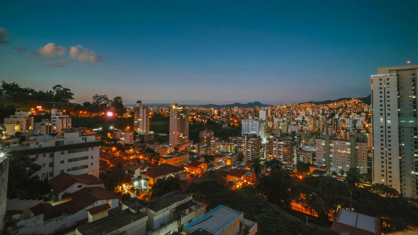 a view of a city at night from the top of a building, colombia, at golden hour, chillhop, flatlay