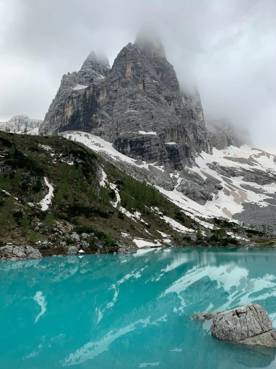 a body of water with a mountain in the background, by Carlo Martini, pexels contest winner, lago di sorapis, majestic spires, puddles of turquoise water, today\'s featured photograph 4k