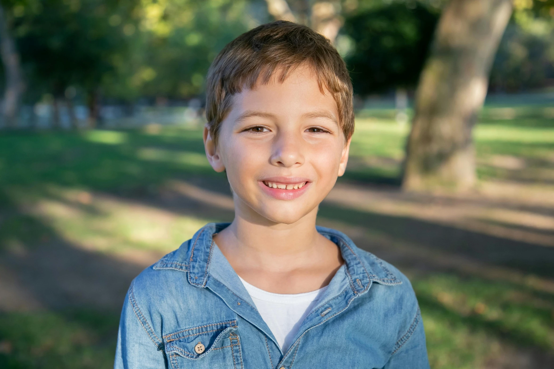 a young boy smiling at the camera in a park, a picture, professional photo-n 3, profile image, digital image