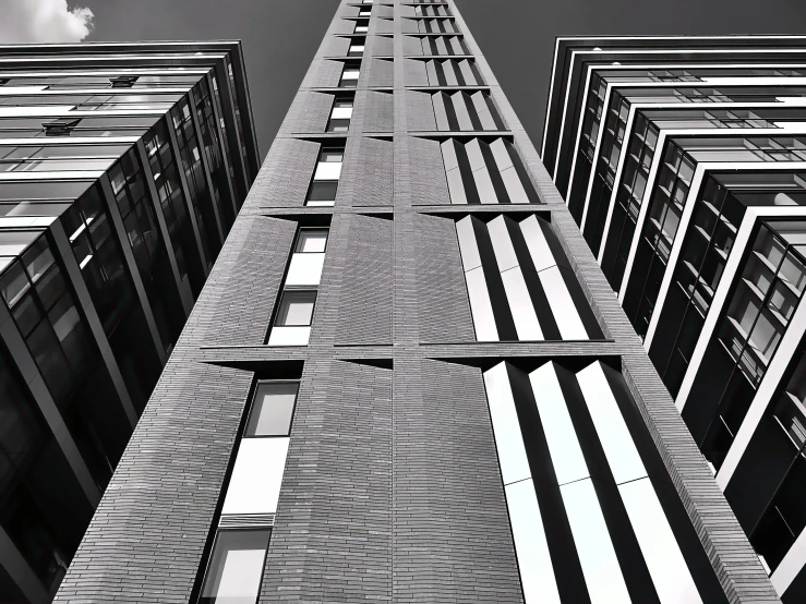 a black and white photo of a tall building, inspired by Alexander Rodchenko, unsplash, monochrome:-2, buildings photorealism, london architecture, tall terrace